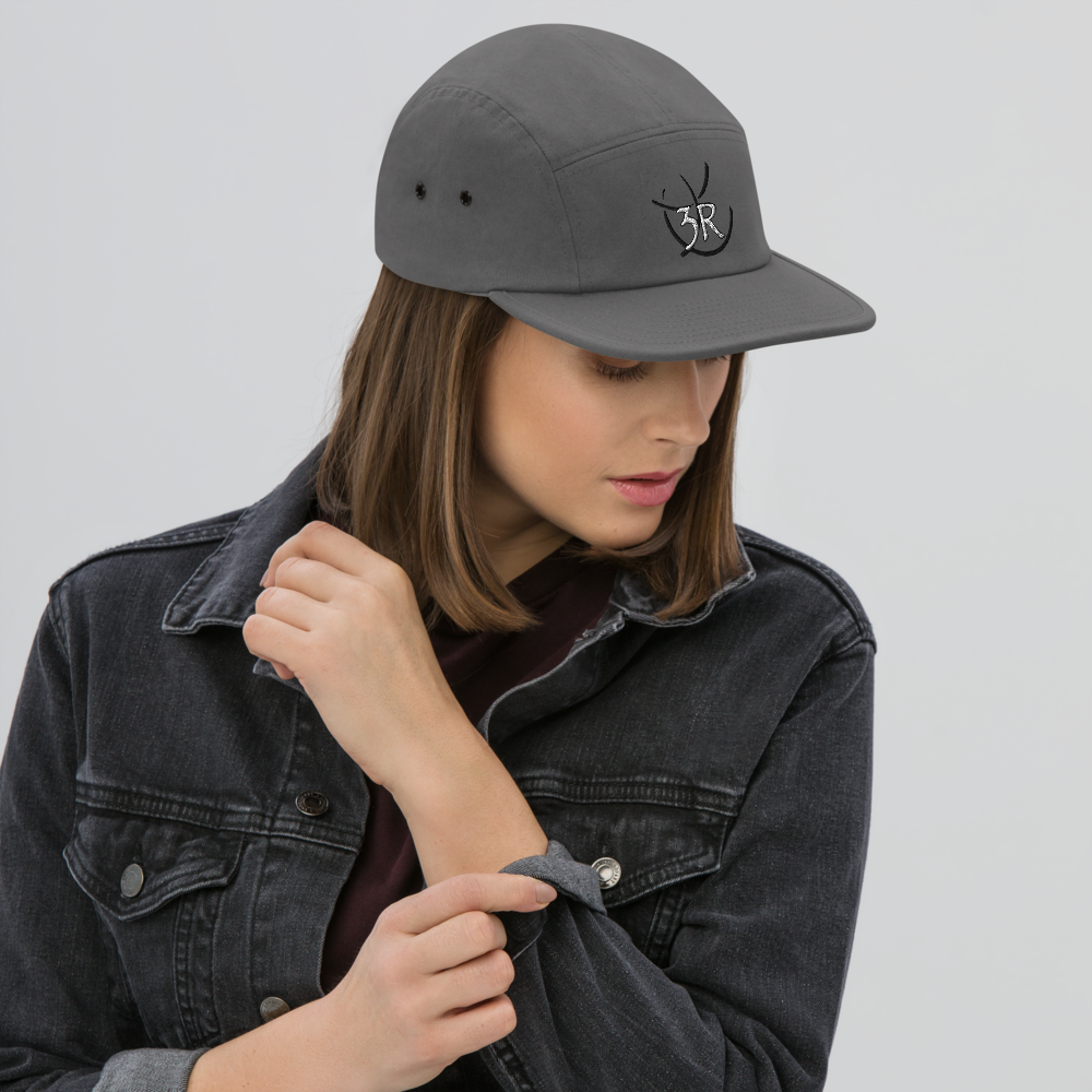 THR33 RINGS double-embroidered five-panel cap — woman wearing grey cap, front lifestyle view