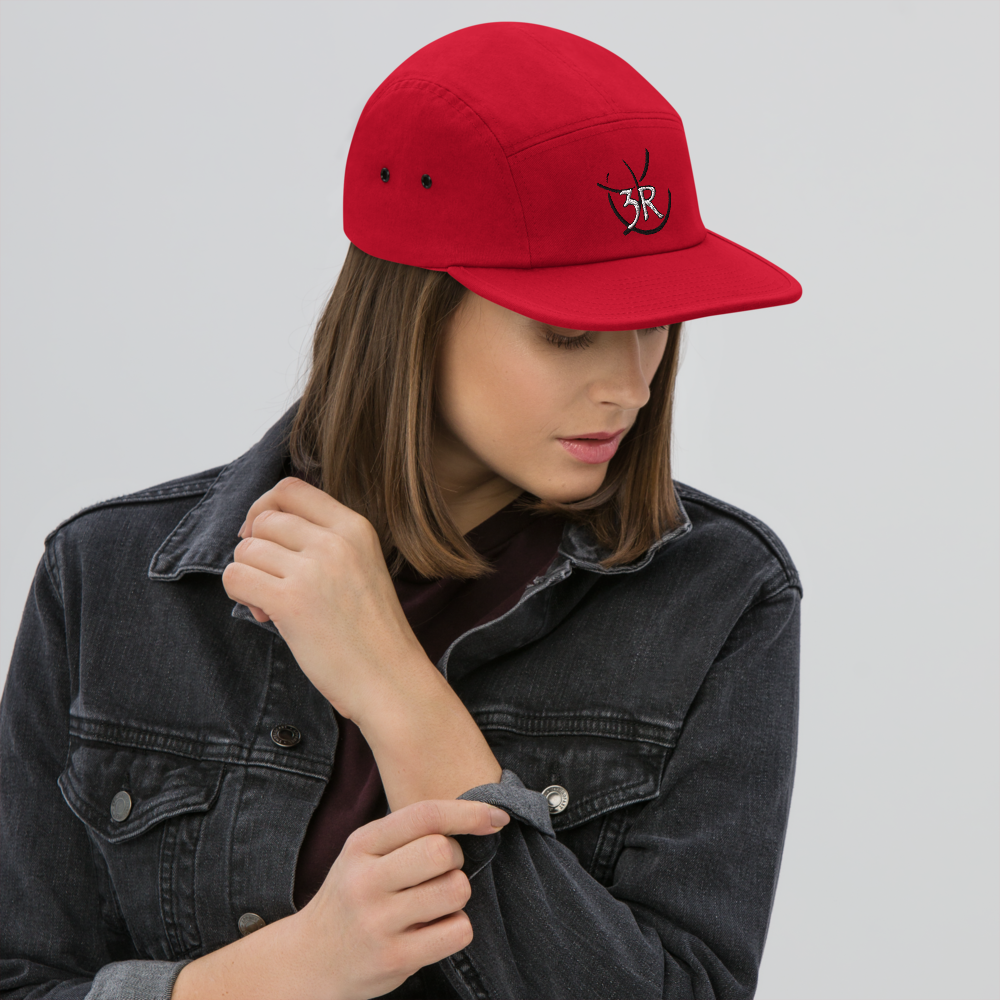 THR33 RINGS double-embroidered five-panel cap — woman wearing red cap, front lifestyle view